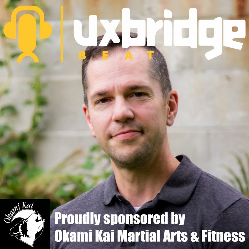A picture of Eric McDougall with the Uxbridge Beat and Okami Kai logos